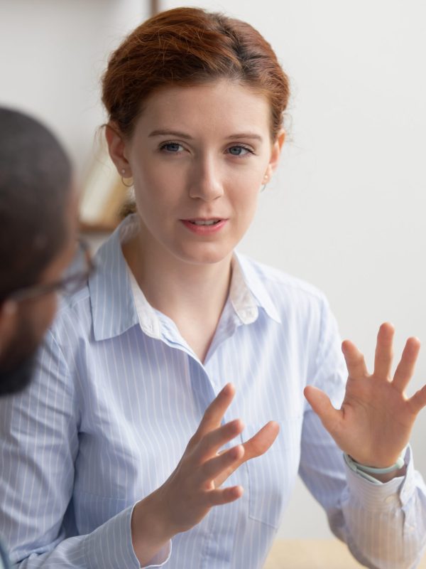 Caucasian businesswoman coach mentor consulting african client intern Business woman coach mentor manager consulting client intern, female caucasian insurance broker bank advisor make offer to african customer at meeting sell services talking explaining deal benefits