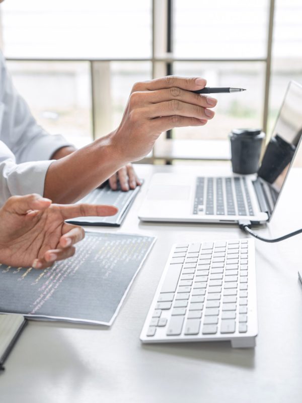 Programmers cooperating at Developing programming and website wo Programmers cooperating at Developing programming and website working in a software develop company office, writing codes and typing data code, Programming with HTML, PHP and javascript.