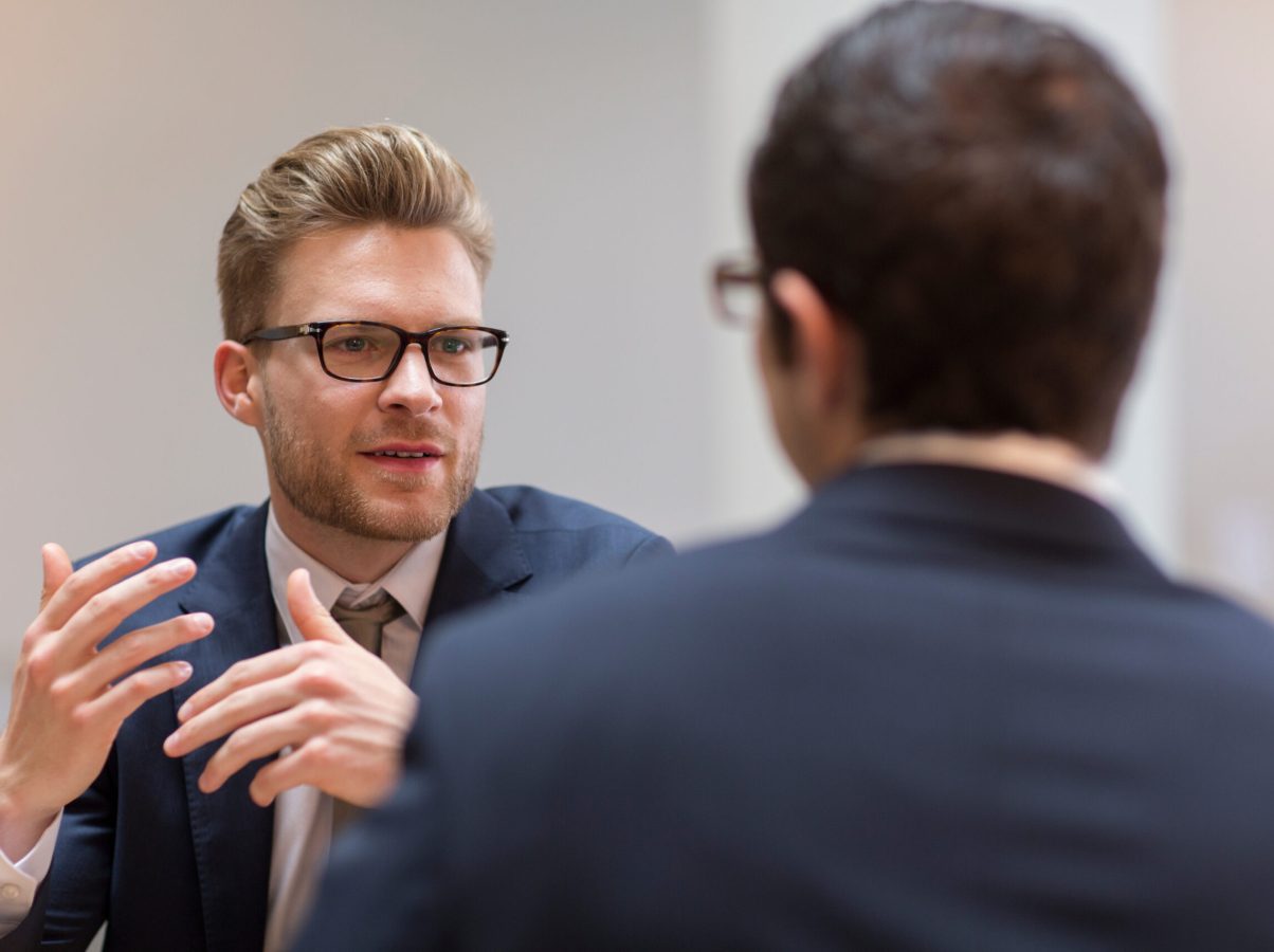 Corporate businessmen talking in meeting Corporate businessmen talking in meeting